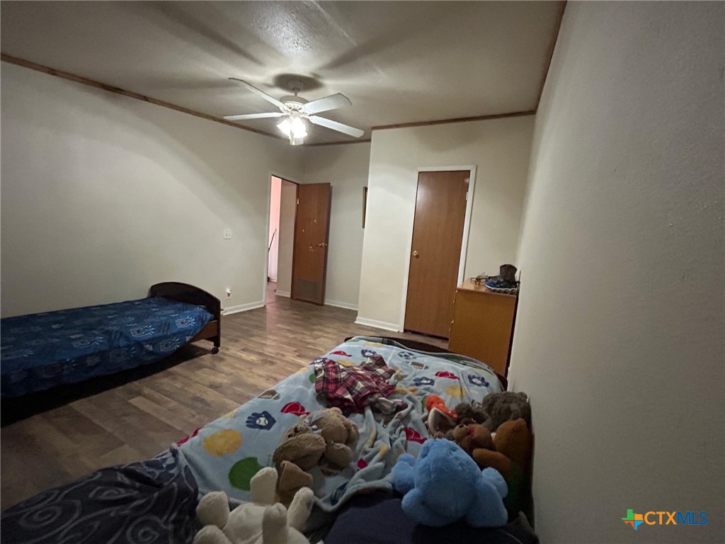 850 Blakely Road Gatesville, TX 76528 - Photo 28 of 32 a bedroom with bed and a chandelier