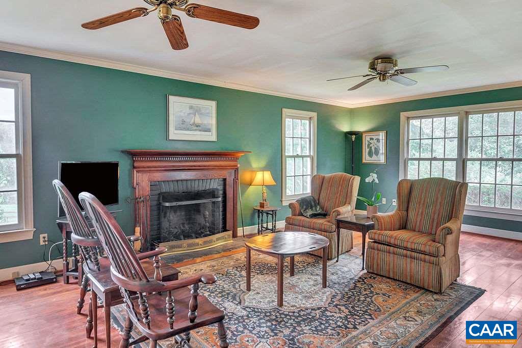674 Gillums Ridge Road Charlottesville, VA 22903 - Photo 12 of 50 a living room with furniture a fireplace and a window