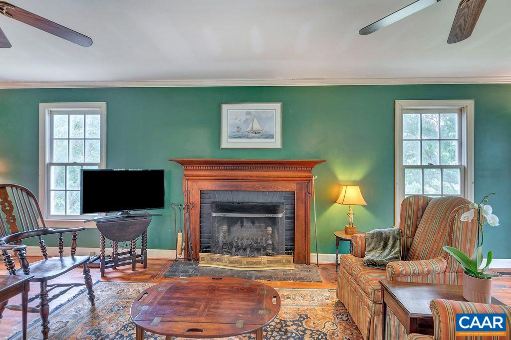 674 Gillums Ridge Road Charlottesville, VA 22903 - Photo 13 of 50 a living room with furniture a fireplace and a flat screen tv
