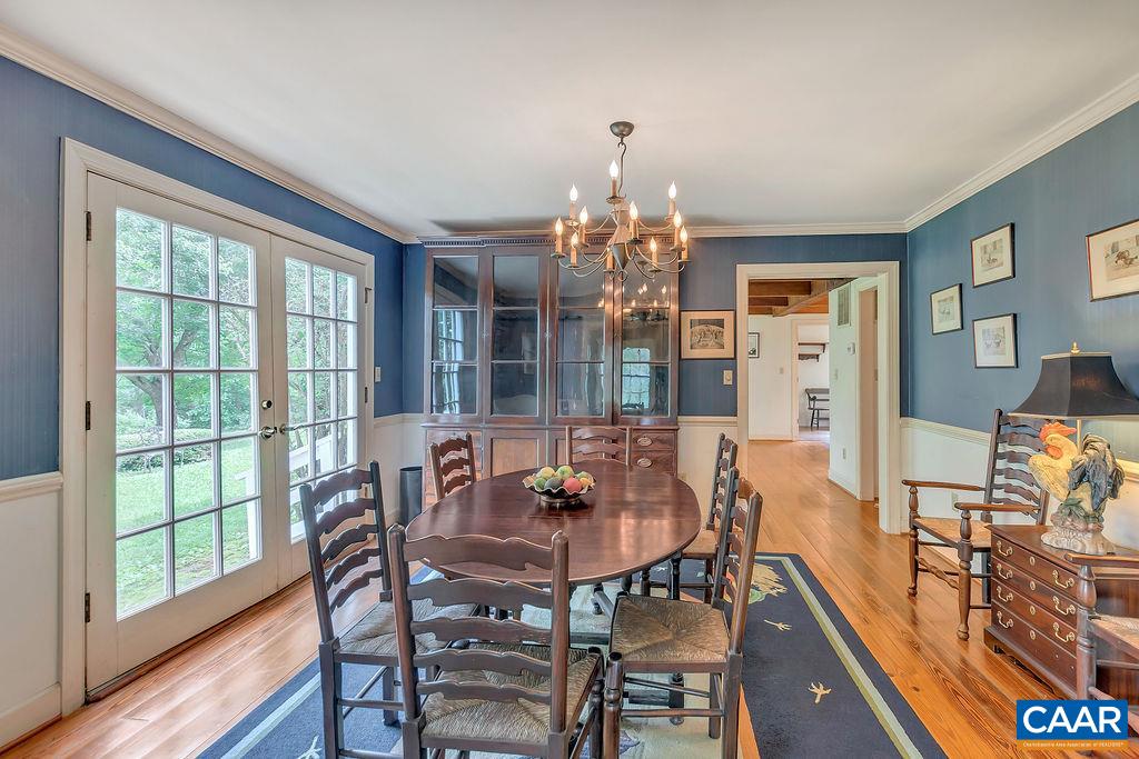 674 Gillums Ridge Road Charlottesville, VA 22903 - Photo 16 of 50 a view of a dining room with furniture a chandelier and wooden floor