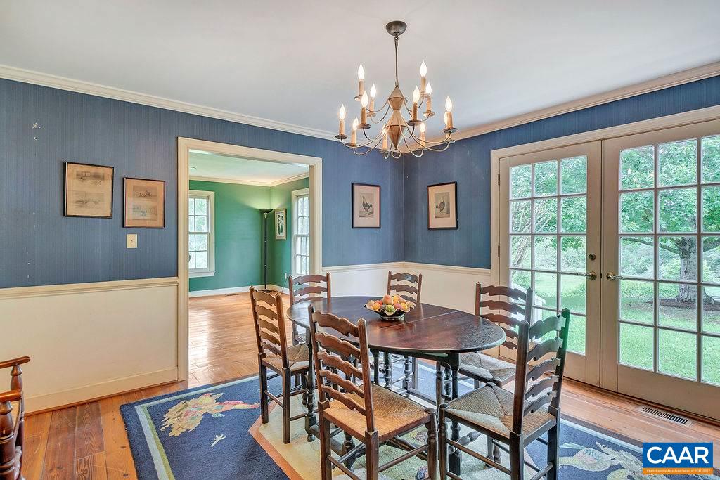 674 Gillums Ridge Road Charlottesville, VA 22903 - Photo 17 of 50 a view of a dining room with furniture a chandelier and wooden floor