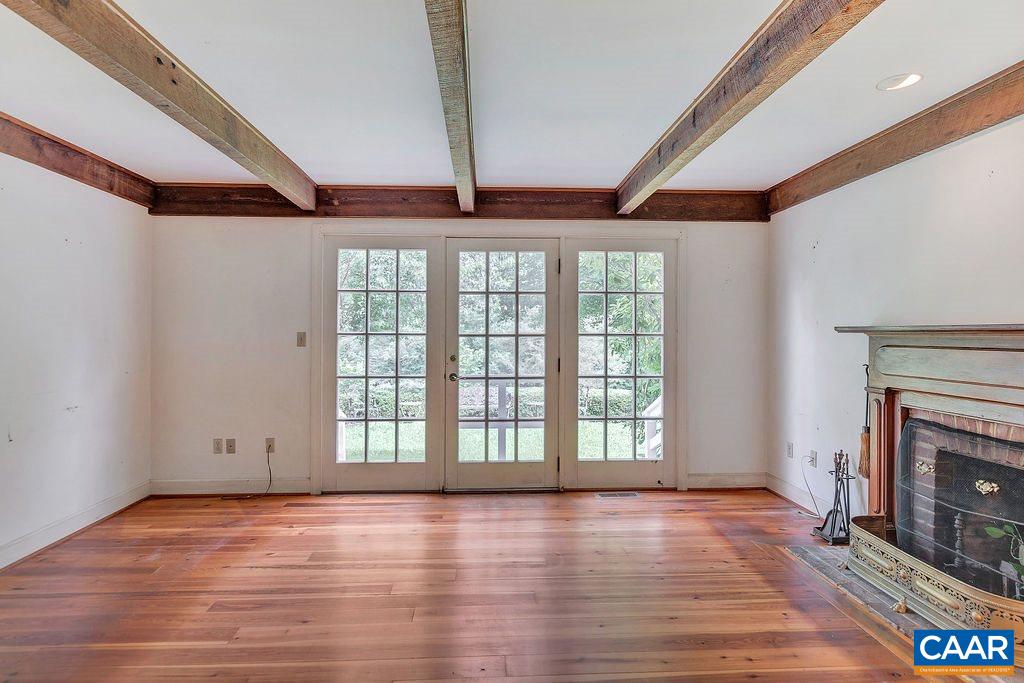 674 Gillums Ridge Road Charlottesville, VA 22903 - Photo 19 of 50 a view of an empty room with wooden floor and a window