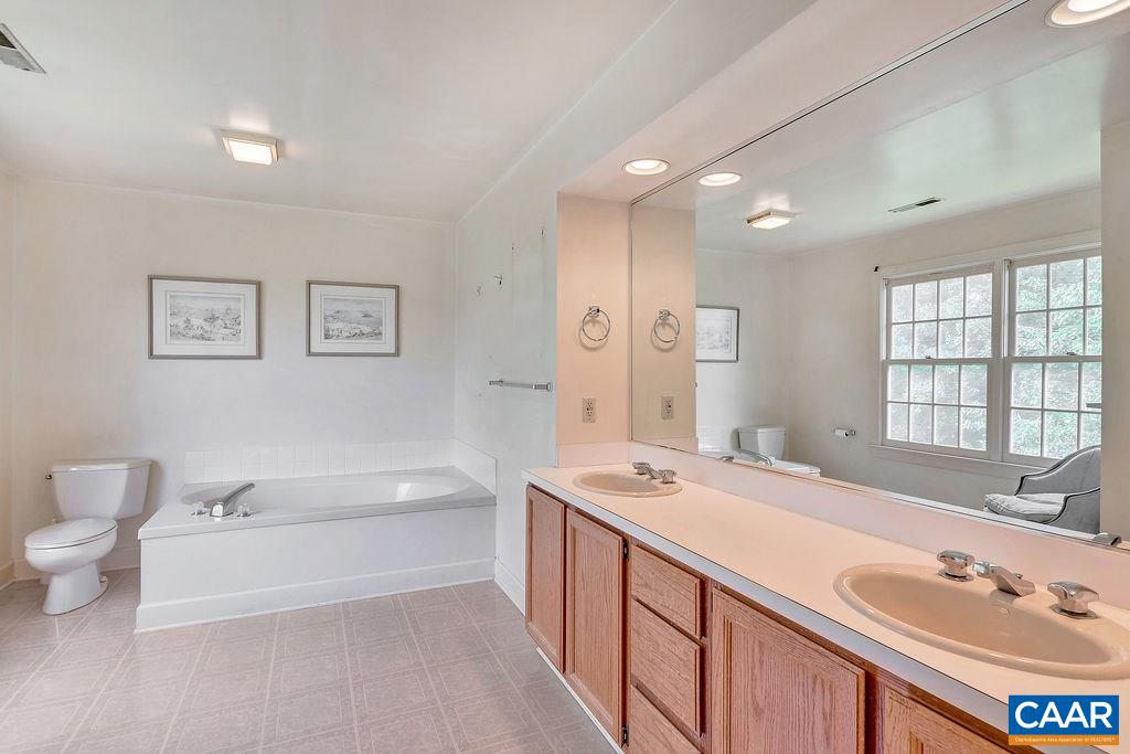 674 Gillums Ridge Road Charlottesville, VA 22903 - Photo 29 of 50 a bathroom with a tub sink and mirror
