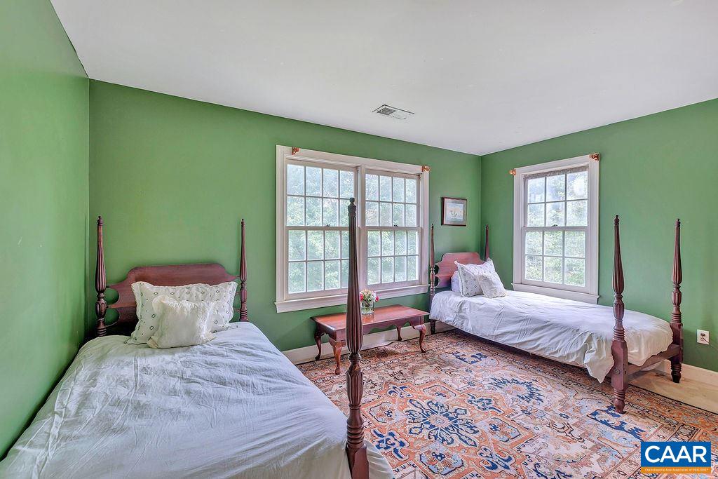 674 Gillums Ridge Road Charlottesville, VA 22903 - Photo 32 of 50 a bedroom with a bed and wooden floor