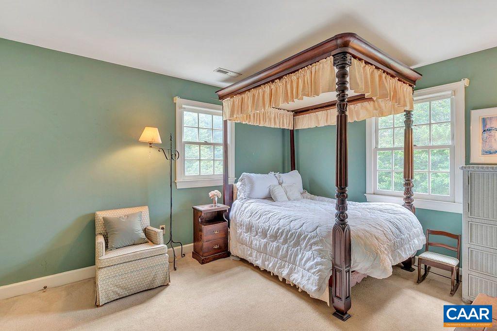 674 Gillums Ridge Road Charlottesville, VA 22903 - Photo 33 of 50 a bedroom with a bed and a large window
