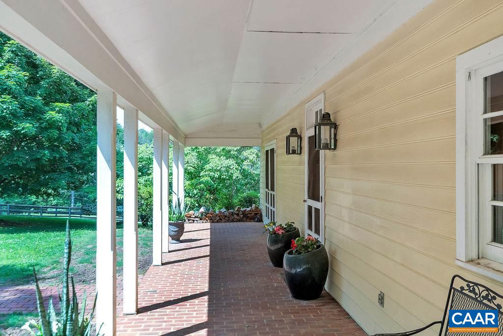 674 Gillums Ridge Road Charlottesville, VA 22903 - Photo 35 of 50 a view of a porch with furniture and garden
