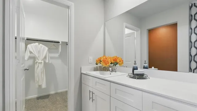 a bedroom with a bed and a mirror