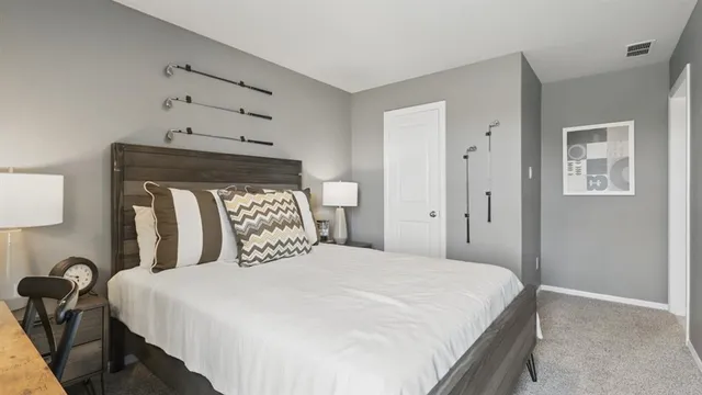 a bedroom with a bed and a lamp on table