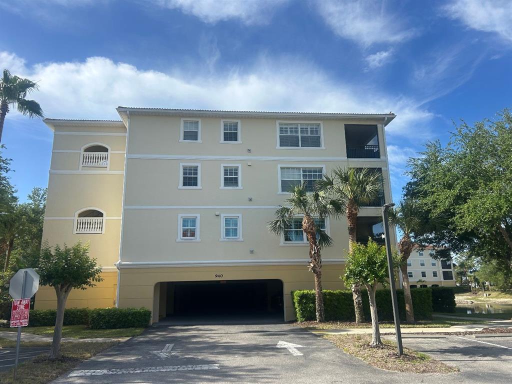 940 Cooper Street, Unit 302 Venice, FL 34285 - Photo 1 of 28 a front view of a house with a yard