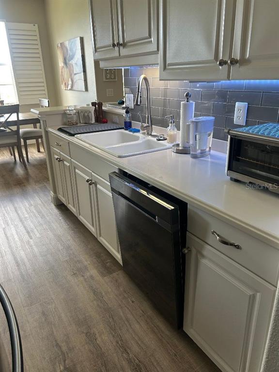940 Cooper Street, Unit 302 Venice, FL 34285 - Photo 12 of 28 a kitchen with stainless steel appliances granite countertop a sink stove and cabinets