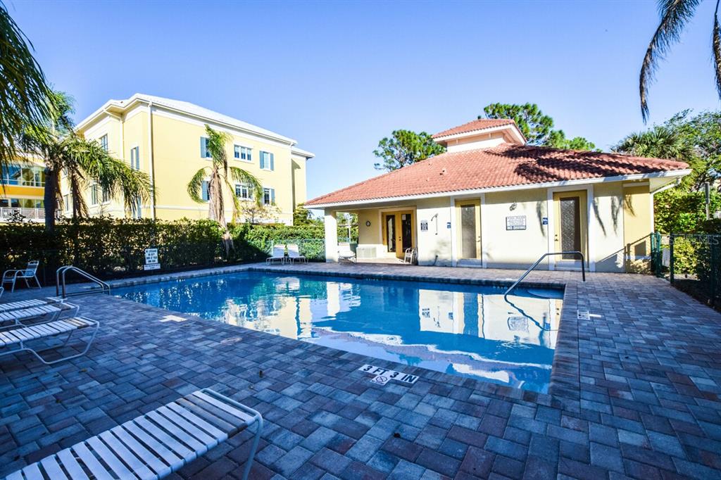 940 Cooper Street, Unit 302 Venice, FL 34285 - Photo 18 of 28 a front view of a house with a yard