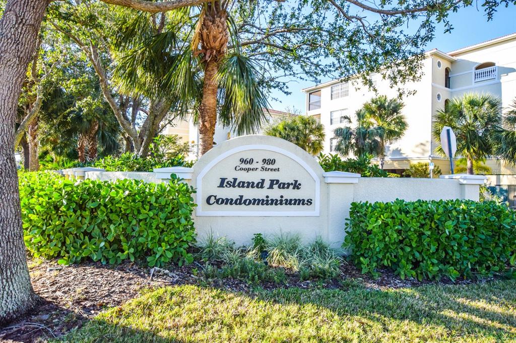 940 Cooper Street, Unit 302 Venice, FL 34285 - Photo 24 of 28 a sign that is sitting in front of a tree