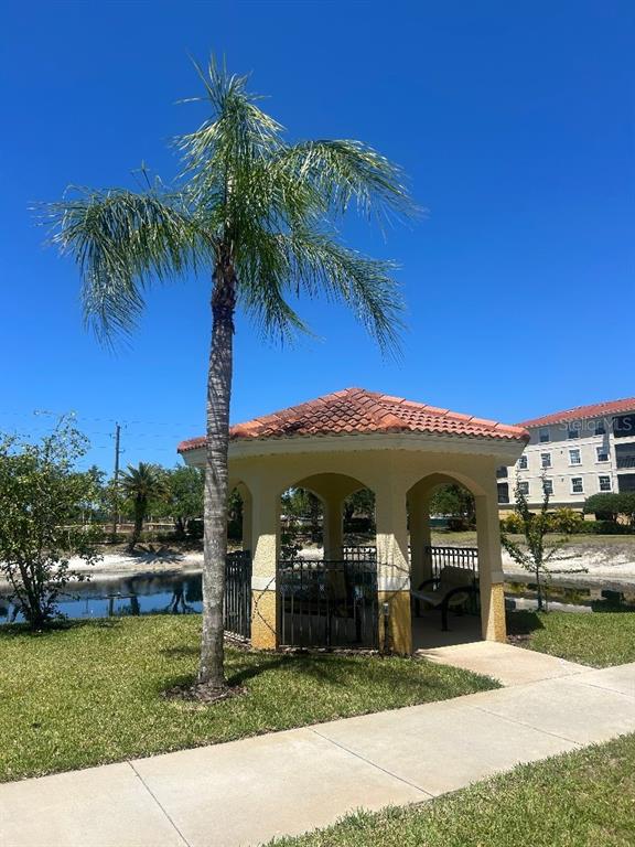 940 Cooper Street, Unit 302 Venice, FL 34285 - Photo 27 of 28 a front view of a house with garden