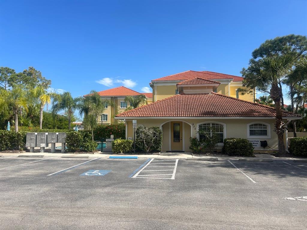 940 Cooper Street, Unit 302 Venice, FL 34285 - Photo 4 of 28 a front view of a house with a yard