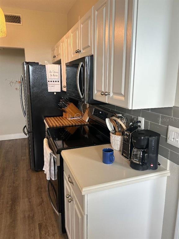 940 Cooper Street, Unit 302 Venice, FL 34285 - Photo 9 of 28 a kitchen with stainless steel appliances a stove a microwave and a refrigerator