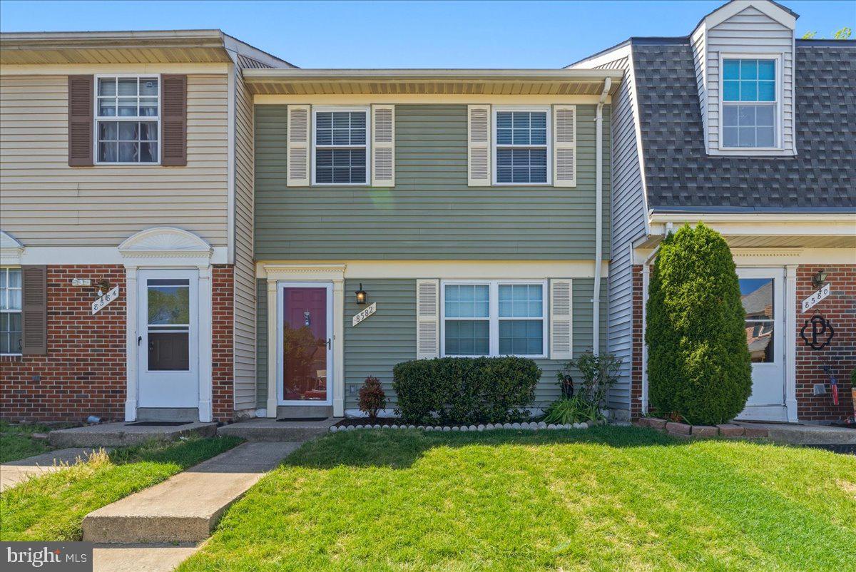8582 Adamson Street Manassas, VA 20110 - Photo 1 of 24 a view of a house with a yard and plants