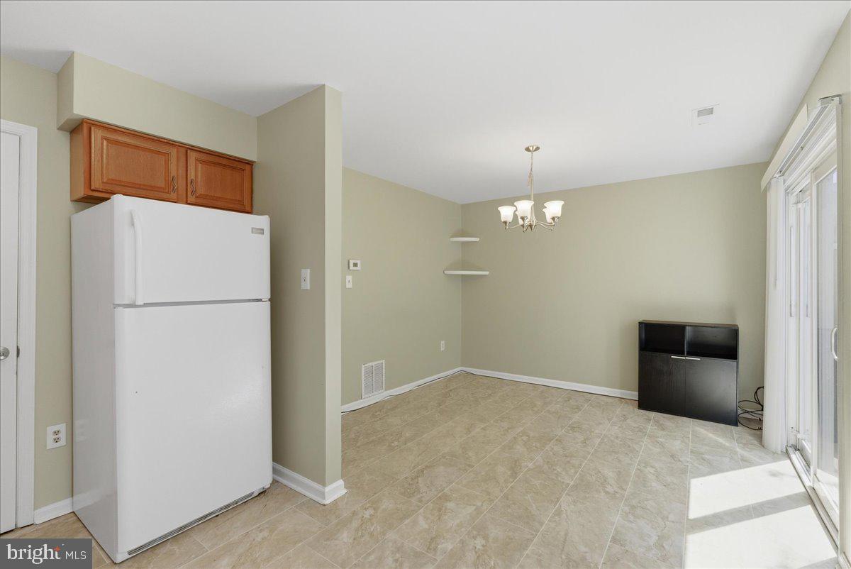 8582 Adamson Street Manassas, VA 20110 - Photo 12 of 24 a view of a kitchen with refrigerator and cabinet