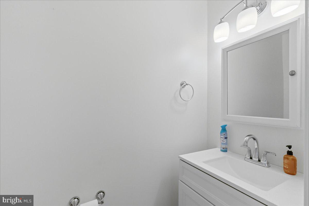 8582 Adamson Street Manassas, VA 20110 - Photo 15 of 24 a bathroom with a sink and a mirror