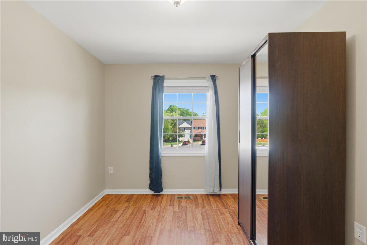8582 Adamson Street Manassas, VA 20110 - Photo 20 of 24 a view of a big room with wooden floor and windows