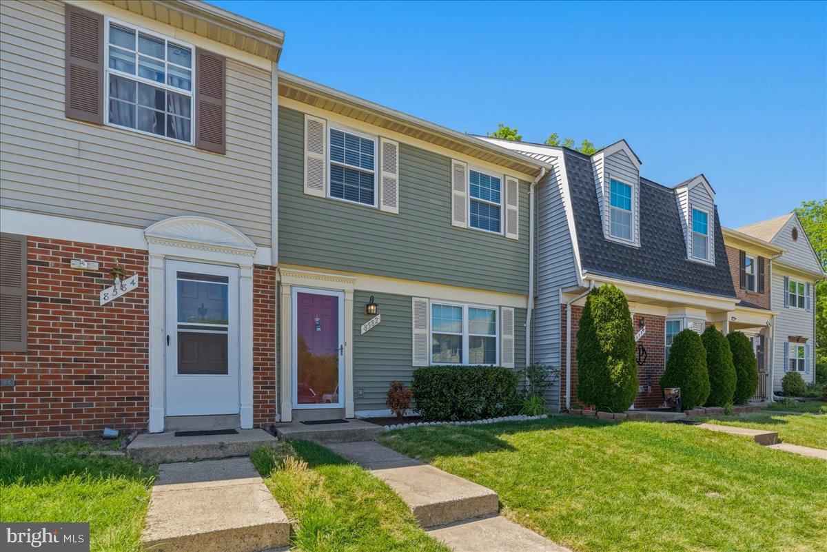 8582 Adamson Street Manassas, VA 20110 - Photo 2 of 24 a front view of a house with garden