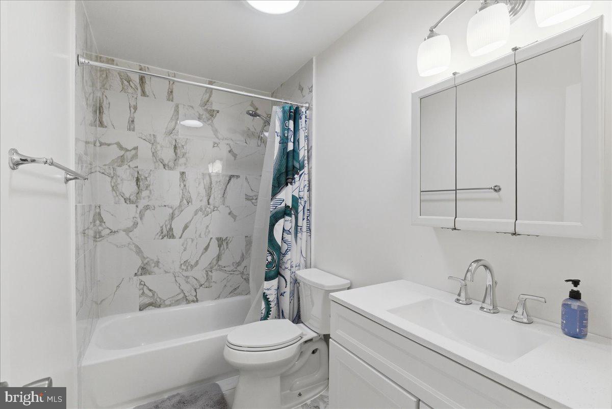 8582 Adamson Street Manassas, VA 20110 - Photo 23 of 24 a bathroom with a sink toilet and shower