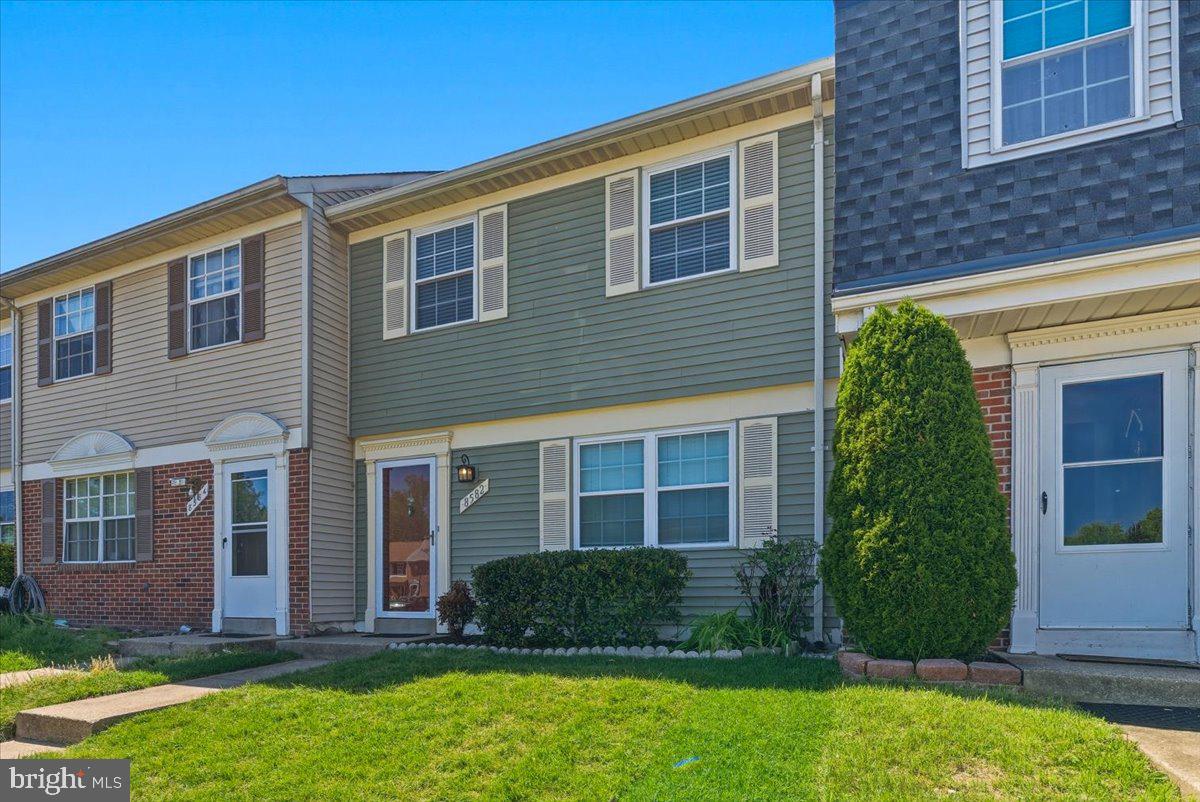 8582 Adamson Street Manassas, VA 20110 - Photo 3 of 24 a front view of a house with a yard