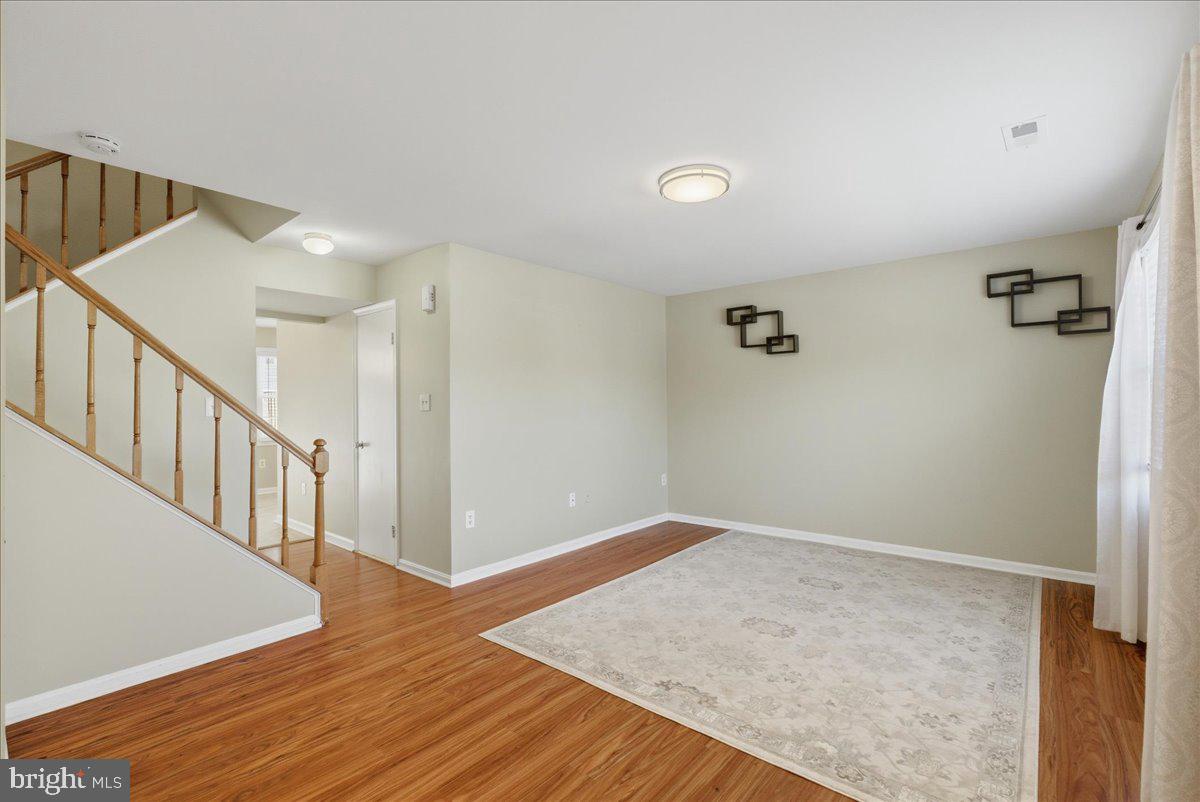 8582 Adamson Street Manassas, VA 20110 - Photo 4 of 24 a view of hallway with stairs and wooden floor