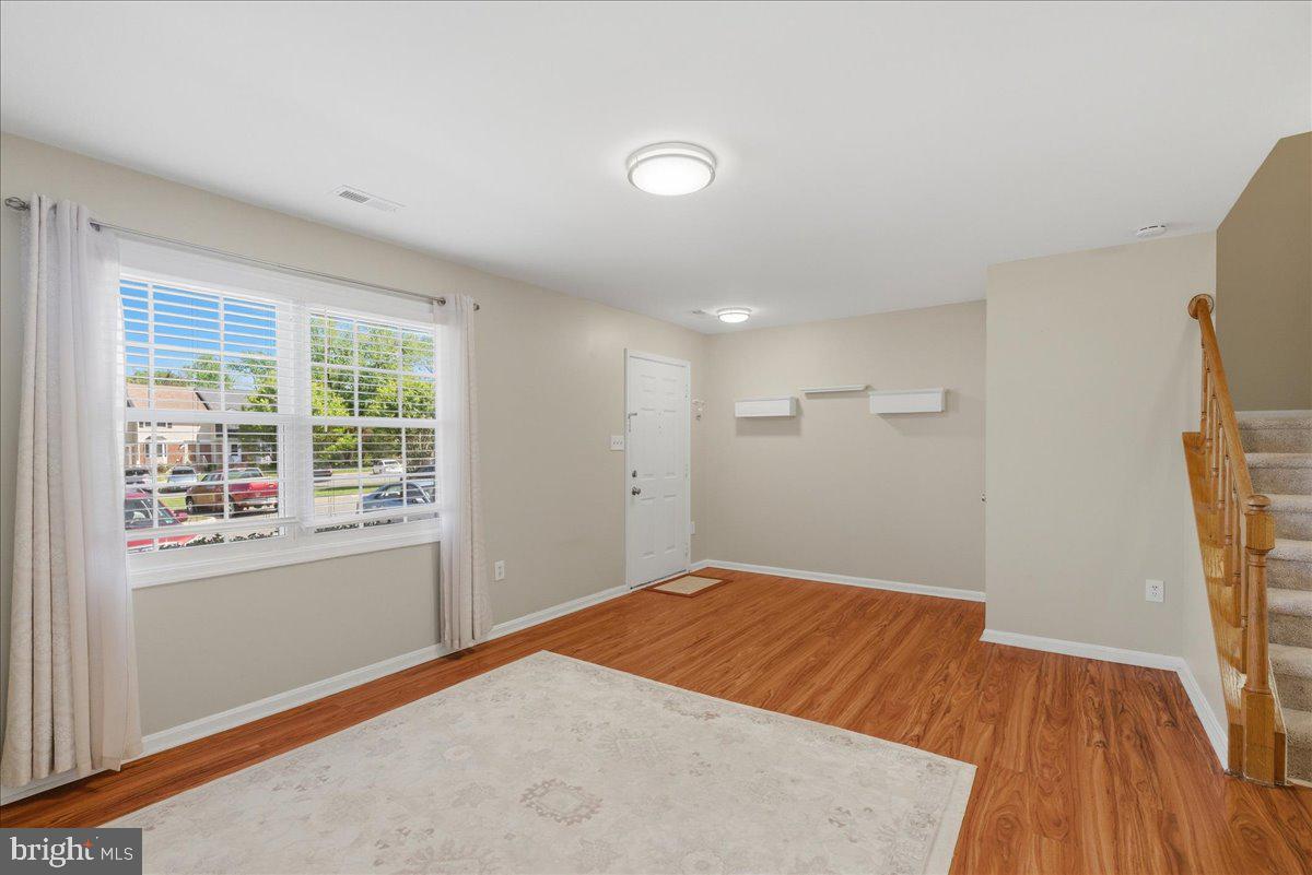 8582 Adamson Street Manassas, VA 20110 - Photo 5 of 24 an empty room with wooden floor and windows