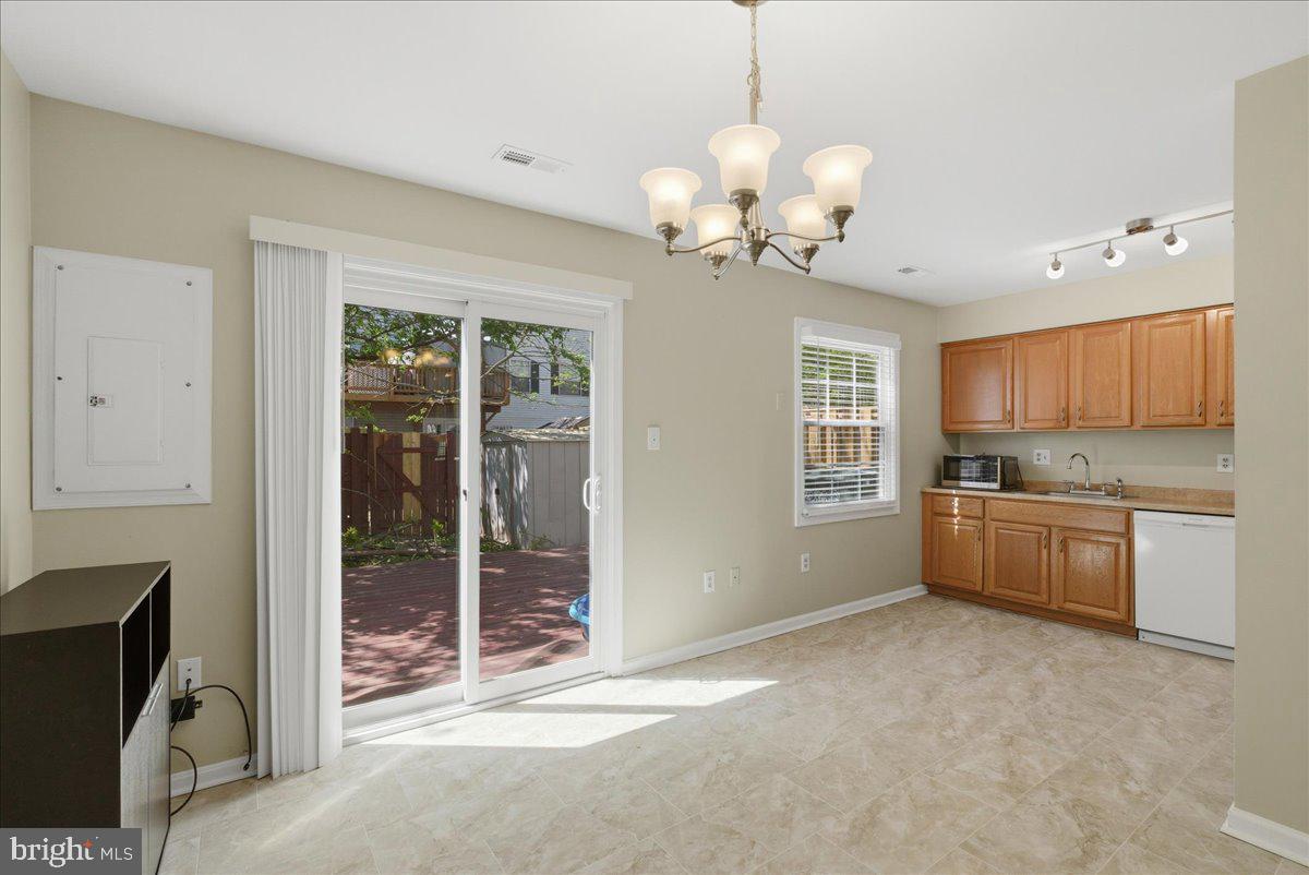 8582 Adamson Street Manassas, VA 20110 - Photo 7 of 24 a view of a kitchen with a sink and refrigerator