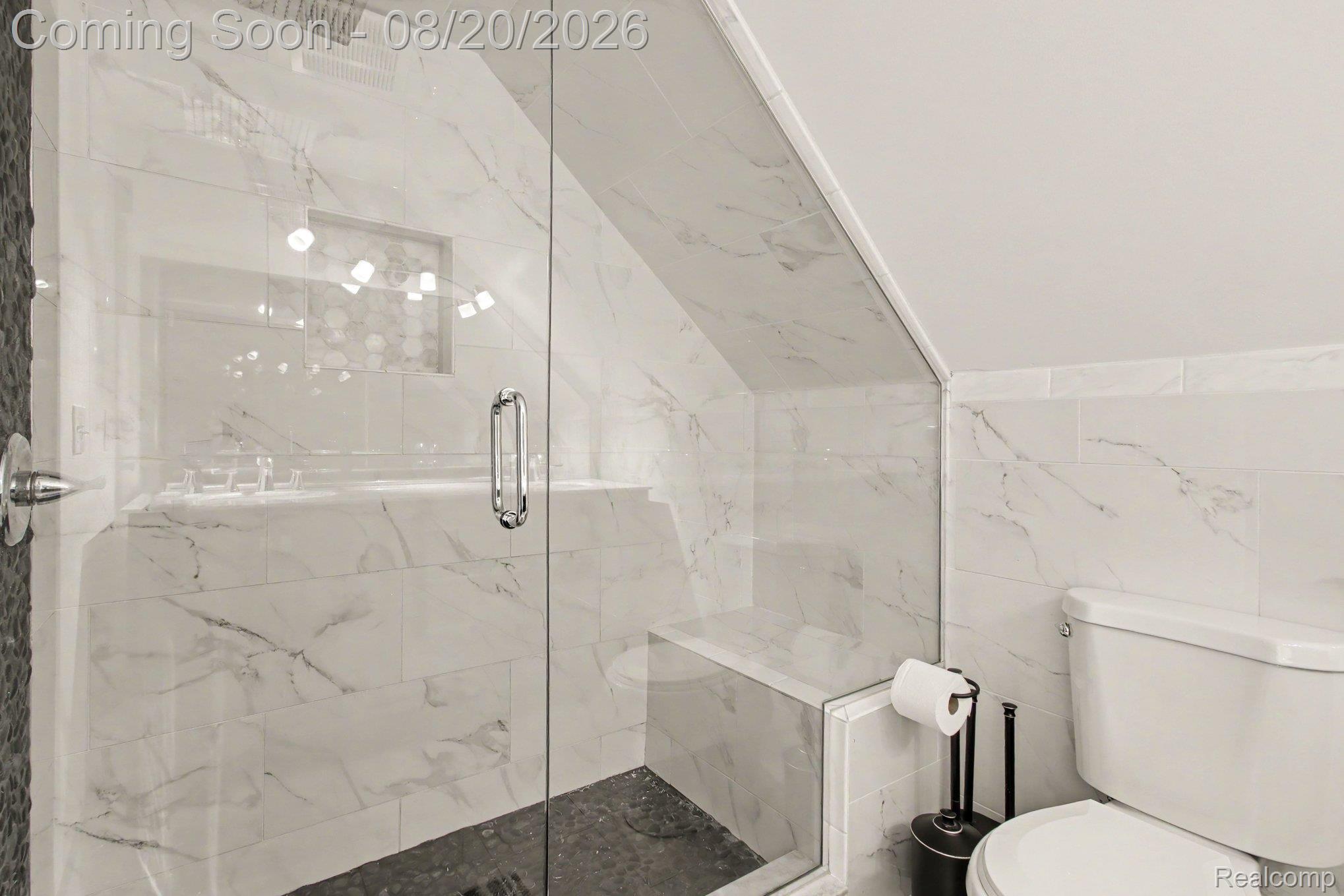 4098 Wakefield Road Berkley, MI 48072 - Photo 29 of 49 Glass-enclosed shower with a built-in bench, tiled with white and gray veined material, and a dark-toned shower floor