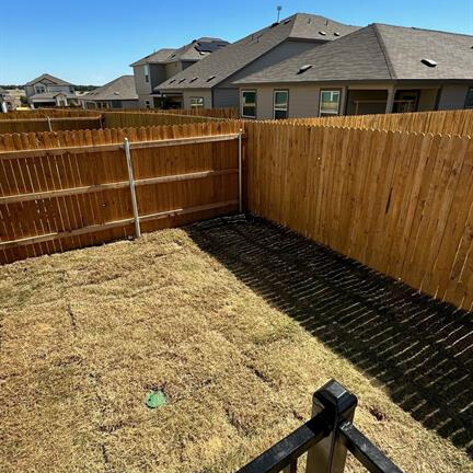 340 The Bad Way Jarrell, TX 76537 - Photo 10 of 14 Fenced backyard featuring a residential view