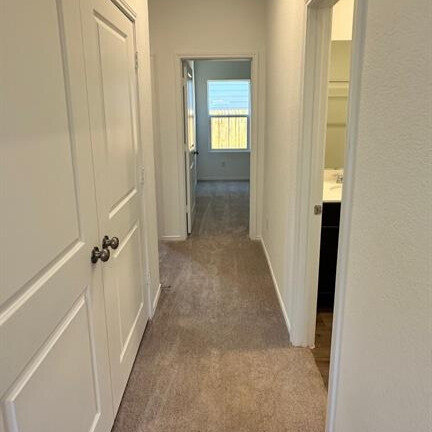 340 The Bad Way Jarrell, TX 76537 - Photo 12 of 14 Hallway featuring light colored carpet and baseboards