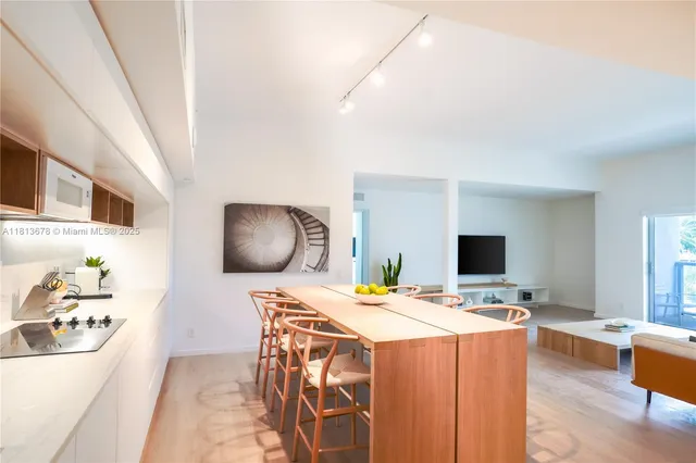 a dining room with furniture and a flat screen tv