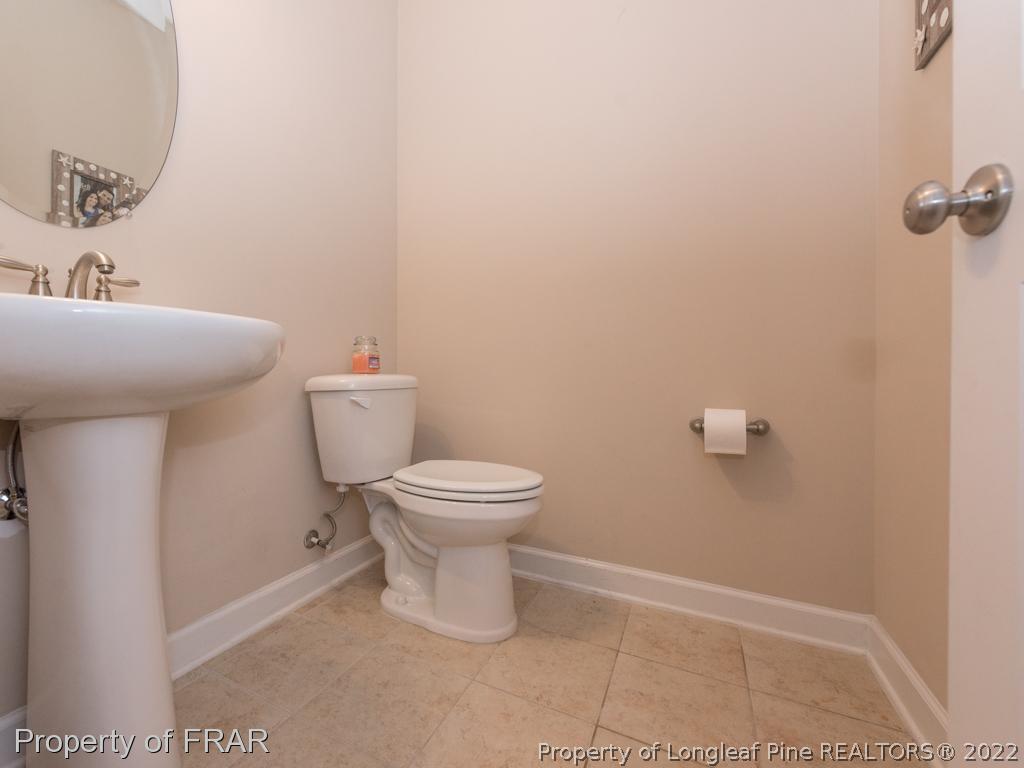 717 St Johns Loop Raeford, NC 28376 - Photo 14 of 29 a white toilet sitting next to a bathroom sink