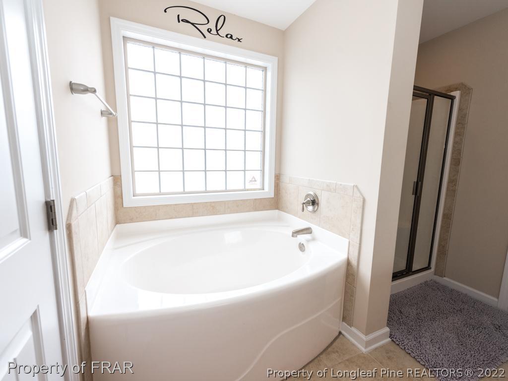 717 St Johns Loop Raeford, NC 28376 - Photo 19 of 29 a white bath tub sitting in a bathroom next to a window