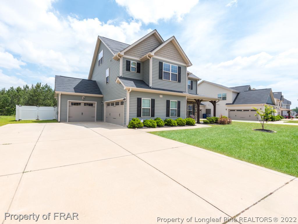 717 St Johns Loop Raeford, NC 28376 - Photo 2 of 29 a front view of a house with a yard