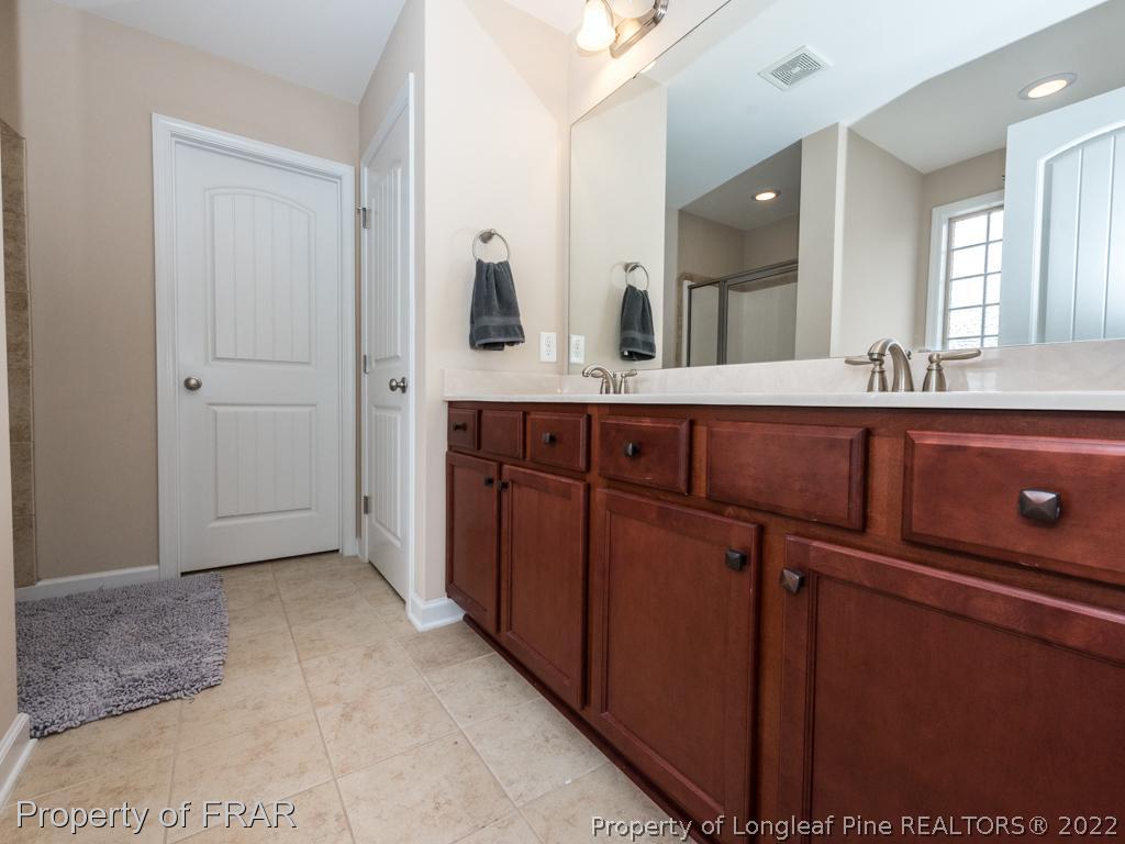 717 St Johns Loop Raeford, NC 28376 - Photo 21 of 29 a spacious bathroom with a sink and mirror