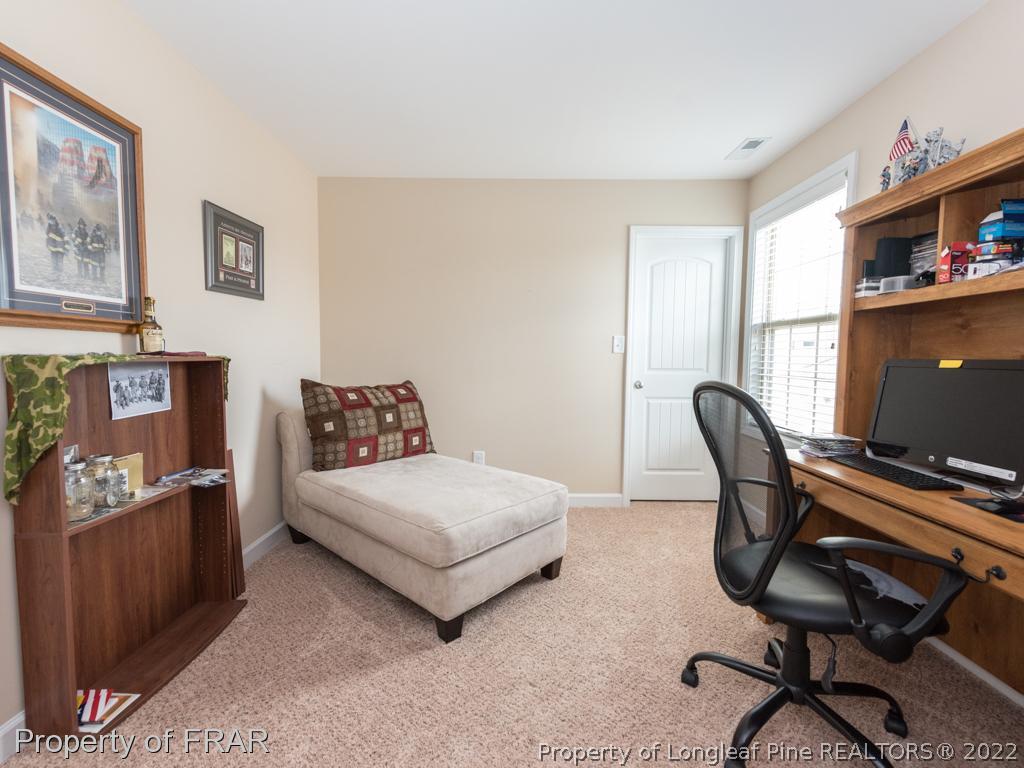 717 St Johns Loop Raeford, NC 28376 - Photo 22 of 29 a bedroom with a bed and a desk