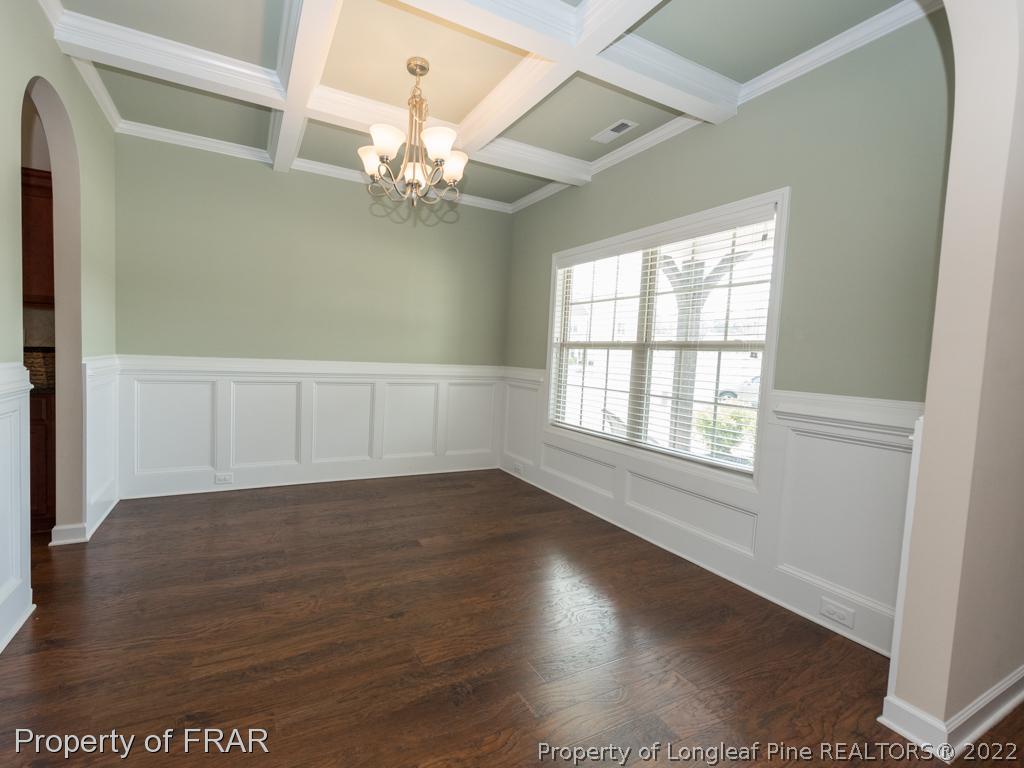 717 St Johns Loop Raeford, NC 28376 - Photo 7 of 29 an empty room with wooden floor and windows