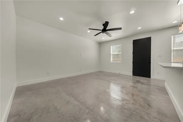 a view of an empty room with windows