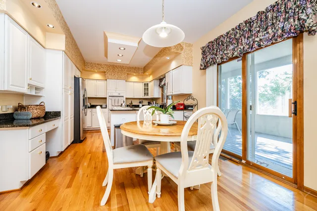 a view of a dining room with furniture a chandelier and wooden floor