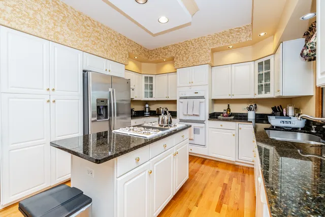 a kitchen with stainless steel appliances granite countertop a sink and cabinets