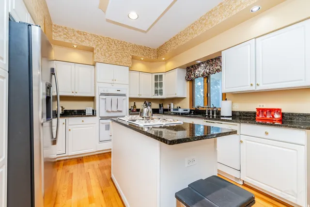 a kitchen with stainless steel appliances granite countertop a sink and cabinets