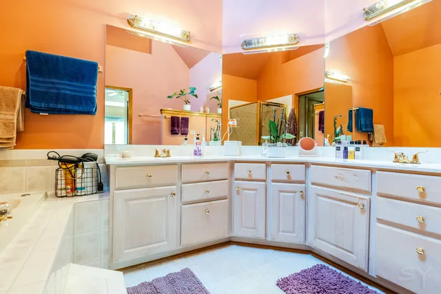 a bathroom with a sink vanity and mirror