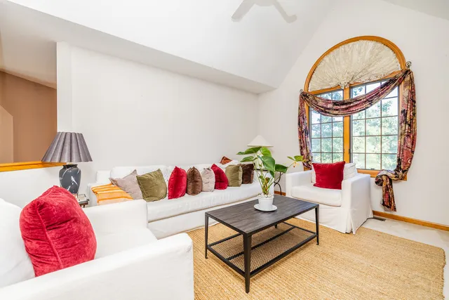 a living room with a couch and a potted plant