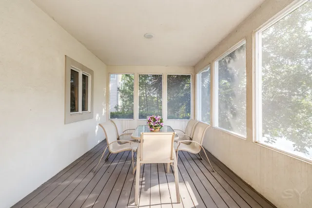 a dining room with furniture window and wooden floor