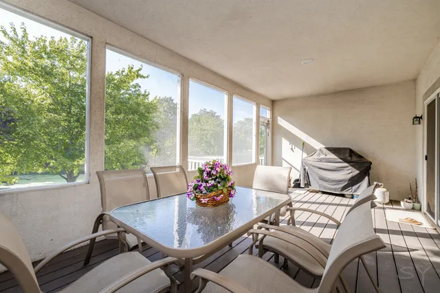 a living room with furniture and floor to ceiling windows