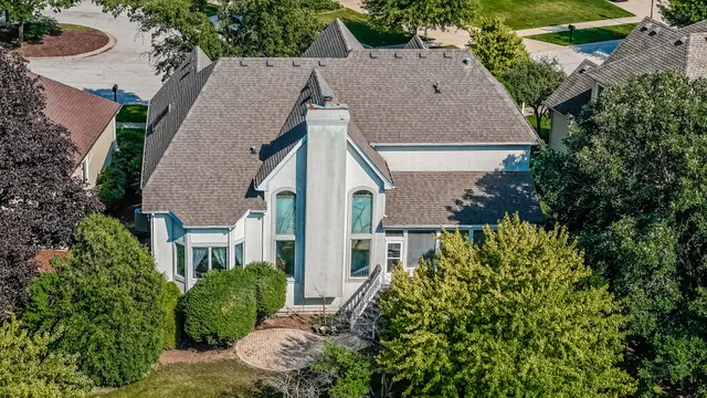 an aerial view of a house with a yard and plants