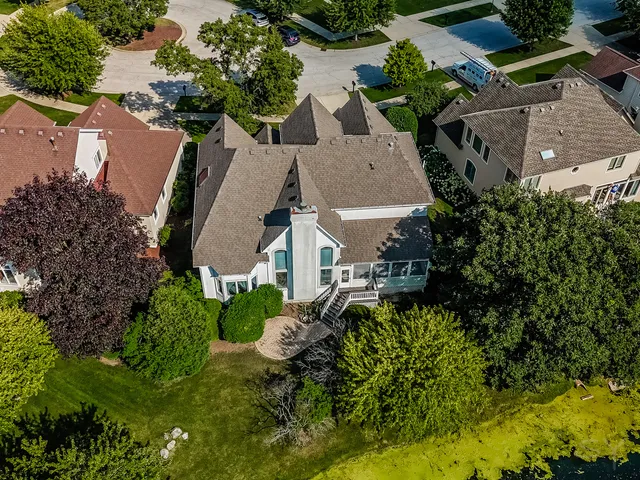 an aerial view of multiple houses with yard