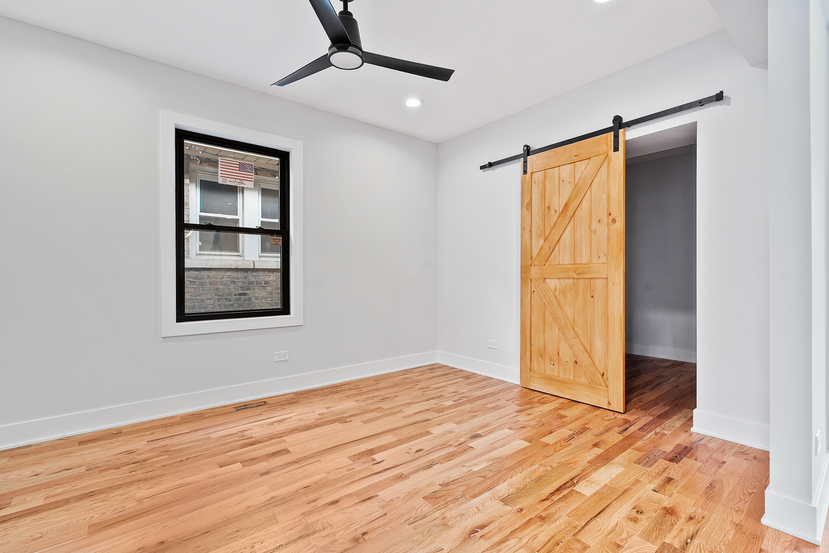 3529 North Nottingham Avenue Chicago, IL 60634 - Photo 13 of 33 a view of an empty room with wooden floor and a window